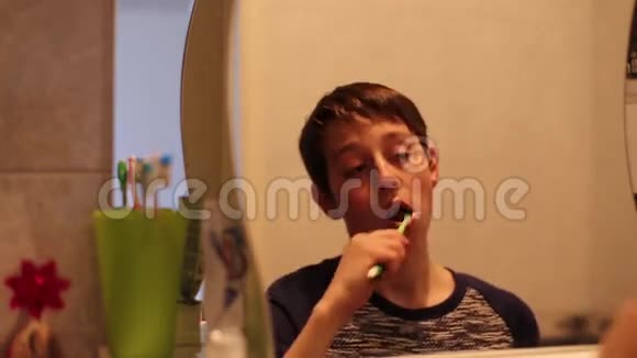 一个男孩在镜子里刷牙视频的预览图