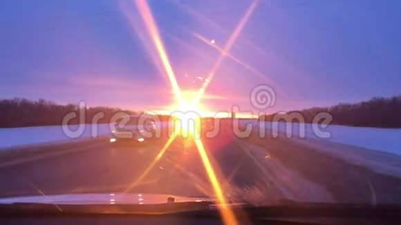 汽车在道路上行驶冬天雪阳光日出旅行视频的预览图