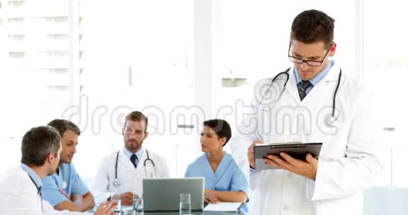 体贴的医生和工作人员在他身后交谈视频的预览图
