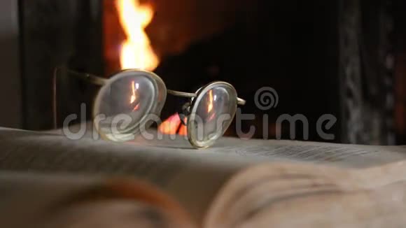 复古眼镜打开书和壁炉视频的预览图