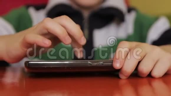 有智能手机的咖啡馆里的男孩视频的预览图
