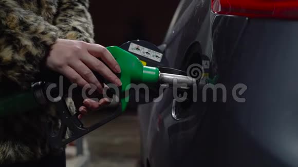 女人在冬天的加油站给她的车加油视频的预览图