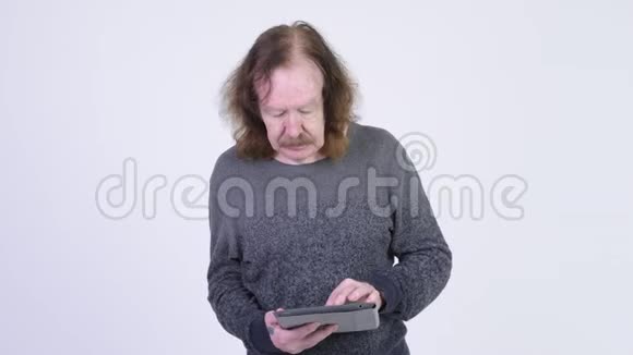 戴胡子的快乐老人用数码平板电脑视频的预览图