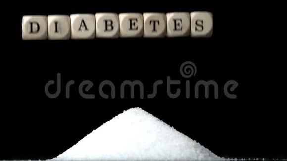白色骰子拼写糖尿病在黑色背景下的糖堆上视频的预览图
