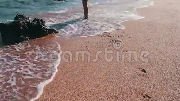 女孩的脚在沙滩上留下脚印视频的预览图