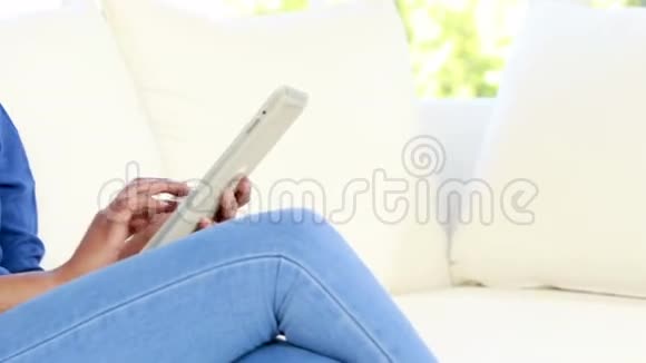 在沙发上用平板电脑的漂亮女人视频的预览图