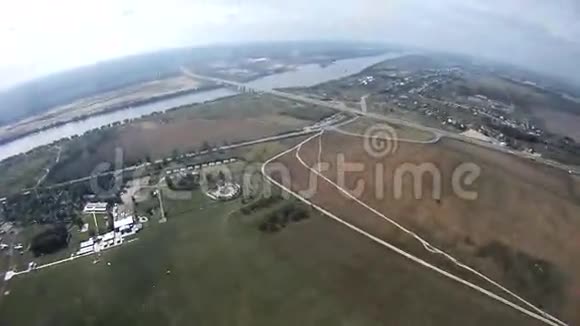 伞兵在空中飞翔河的景观绿野极限运动视频的预览图