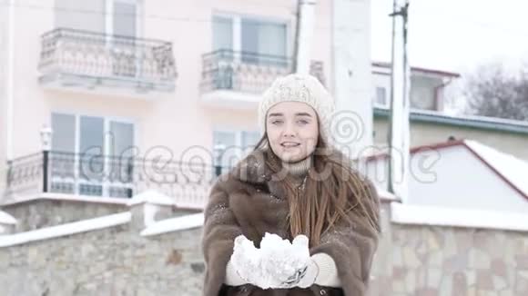 快乐的年轻女孩吐雪和笑慢慢地视频的预览图