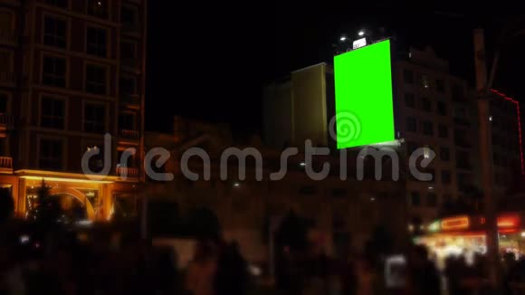 墙上的空白广告牌拥挤的街道夜晚绿色的屏幕视频的预览图