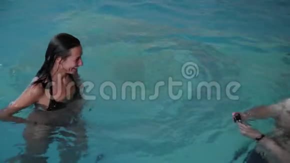 男人和女人在游泳池里游泳视频的预览图