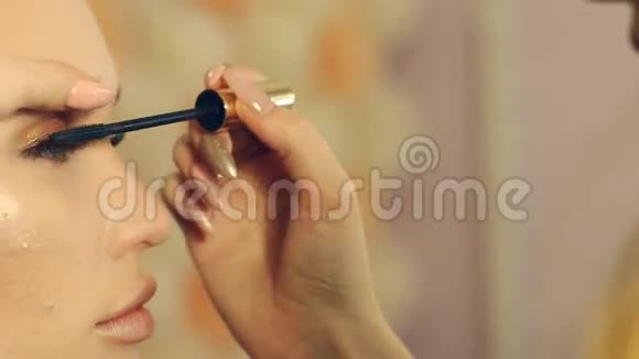 一个金发女孩在美容院接受化妆的镜头视频的预览图
