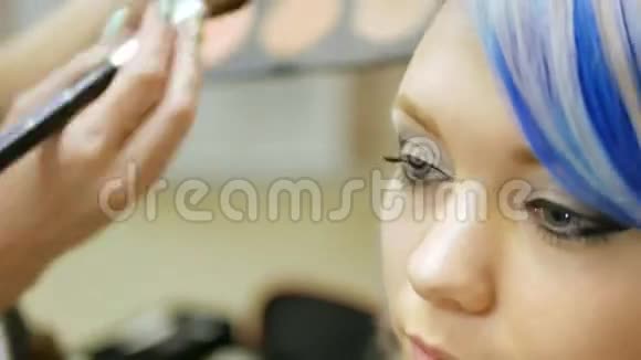 职业化妆师一个蓝发的年轻女孩视频的预览图