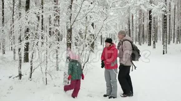 快乐的家庭冬季乐趣户外在雪林视频的预览图