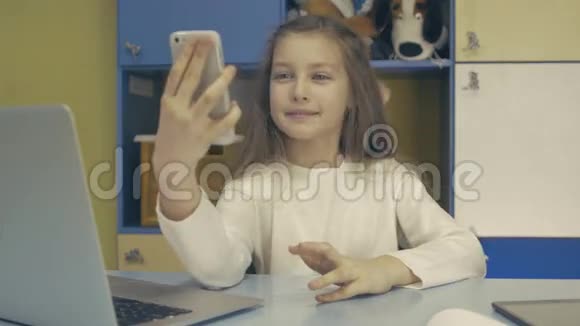 可爱的小女孩使用现代智能手机视频的预览图