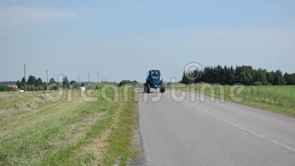拖拉机在农村公路和草捆农业领域行驶视频的预览图