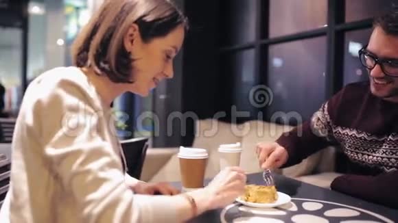 快乐的一对夫妇在咖啡厅吃蛋糕吃甜点视频的预览图