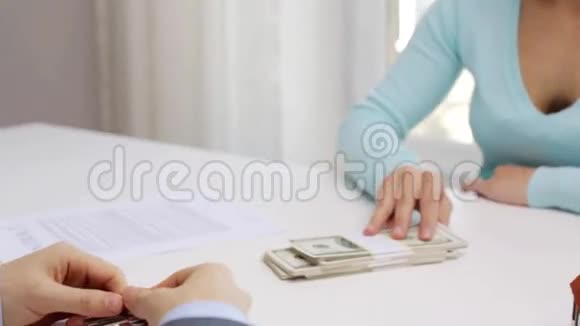 女人付钱给房地产经纪人拿房子钥匙视频的预览图