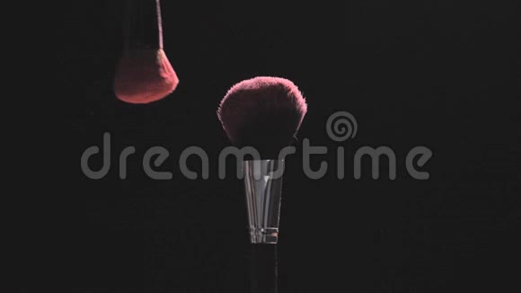 在黑色背景上用粉色粉末做的化妆刷慢动作视频的预览图