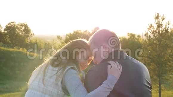 日落时分年轻幸福的一对夫妇的后景视频的预览图