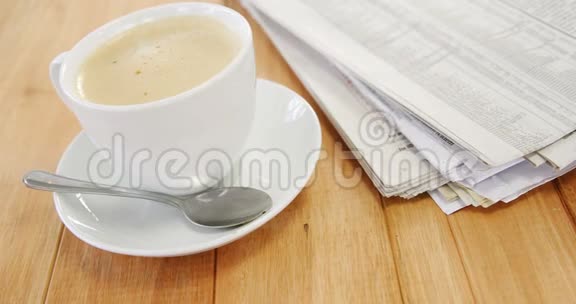 咖啡和报纸放在木板上视频的预览图