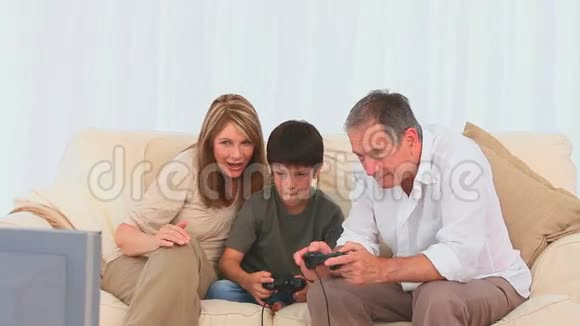一个男孩和他爷爷玩电子游戏视频的预览图