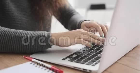 微笑的女商人在办公室笔记本电脑上打字视频的预览图