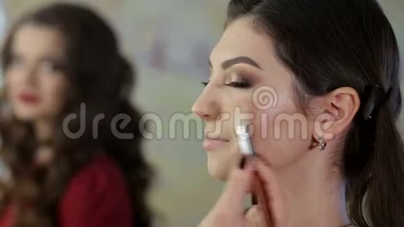 化妆师在沙龙为美女做化妆美容理念视频的预览图