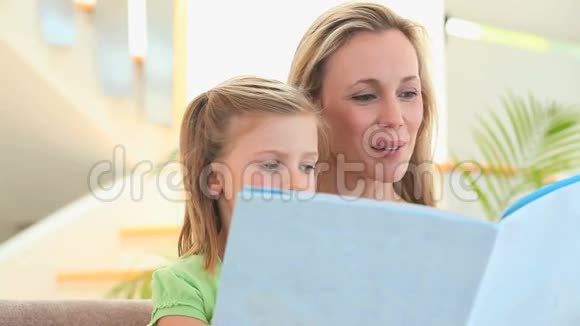 妈妈在给金发女儿读故事视频的预览图