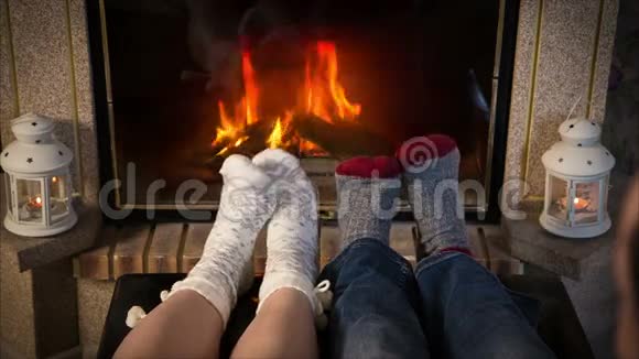 两只羊毛袜子的腿在壁炉附近加热视频的预览图