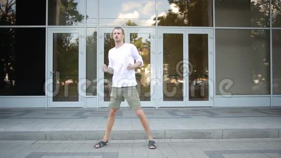 快乐的白种人舞蹈家男子时髦的街头舞蹈自由式城市视频的预览图