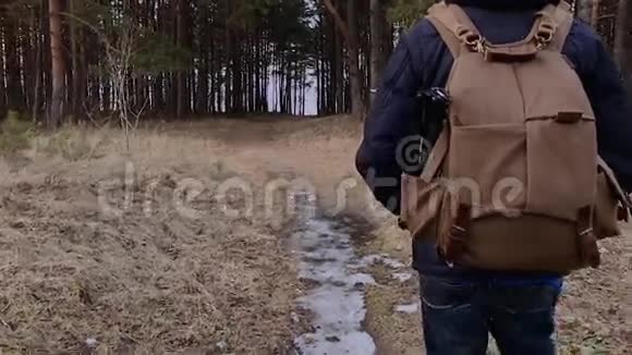 摄像机追逐着那个人当他带着背包在森林里散步时他就走了视频的预览图