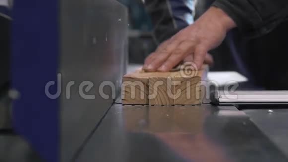 一个人用台锯砍柴打磨现代家具厂视频的预览图