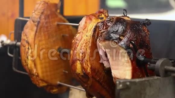 大块美味的猪肉火腿在明火上煮熟街头美食户外食品露营和烹饪视频的预览图