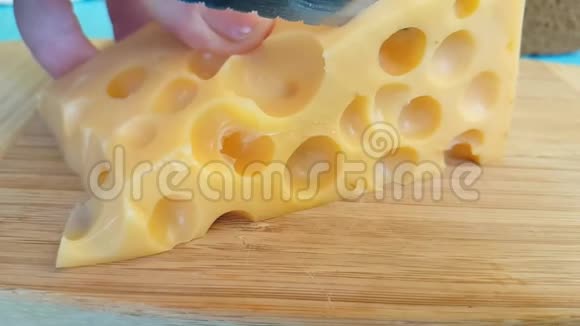 奶酪瑞士人用刀切在木板上视频的预览图