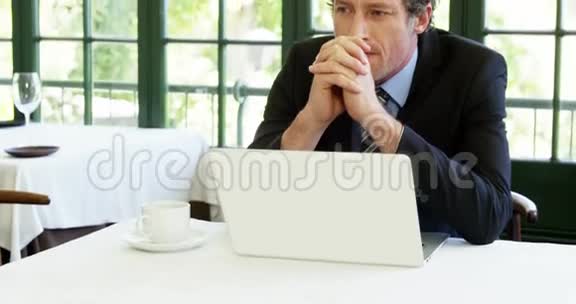 一位体贴的商人坐在笔记本电脑前的特写镜头视频的预览图