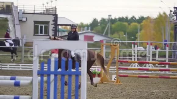 慢动作骑马的年轻女子在马术比赛中表演视频的预览图