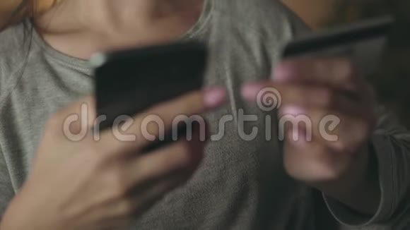 女人在家里用信用卡和智能手机在线支付视频的预览图