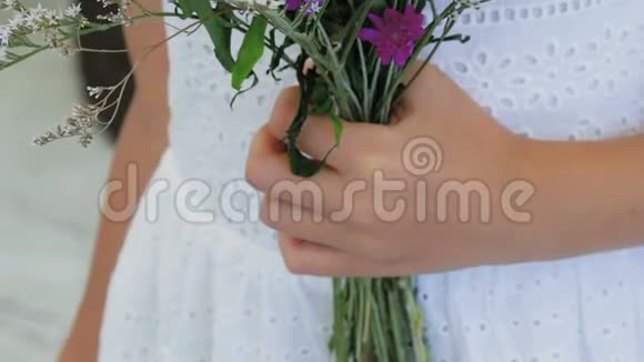 少女手中的野花的花束慢慢地视频的预览图