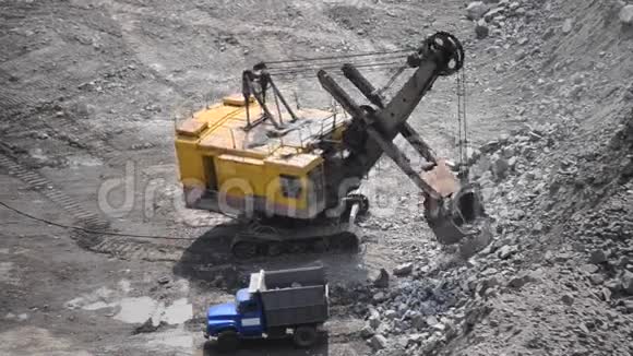 巨大的挖掘机和卡车以及一个人的花岗岩采石场视频的预览图