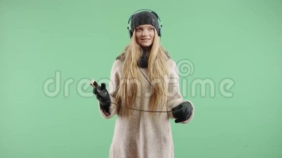 冬天戴耳机听音乐的快乐女孩视频的预览图