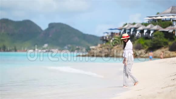 在热带海滨玩得很开心的年轻美女视频的预览图