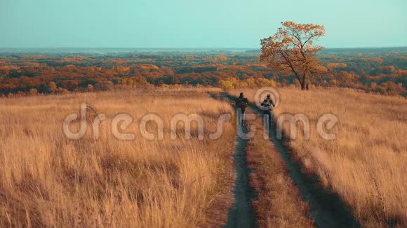 人们在大自然中旅行秋天的冒险慢动作视频带背包的两个徒步旅行者户外生活方式视频的预览图
