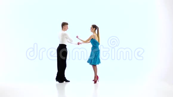 专业舞者配对表演桑巴白色背景慢动作视频的预览图