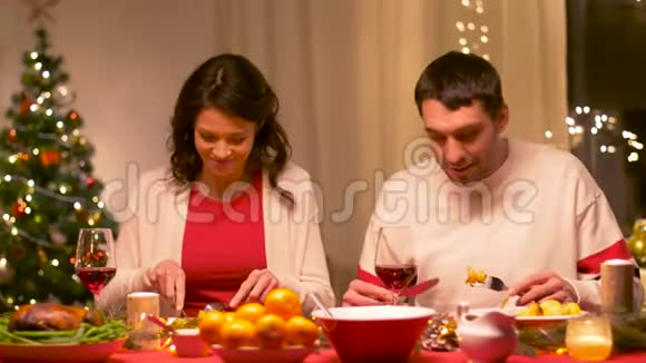 快乐的一对夫妇在圣诞晚餐上吃饭视频的预览图