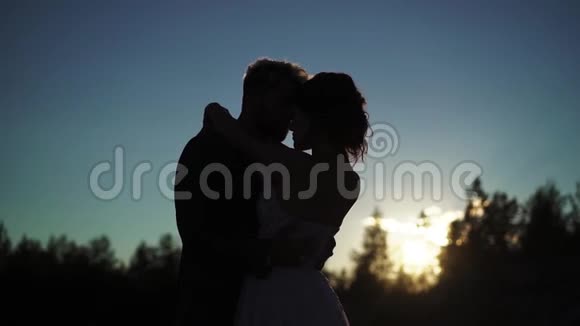 年轻可爱的情侣拥抱剪影视频的预览图