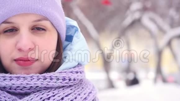 一位看着镜头的迷人年轻女子的冬季画像视频的预览图