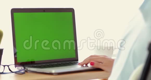 女士使用笔记本电脑与关键的绿色屏幕视频的预览图