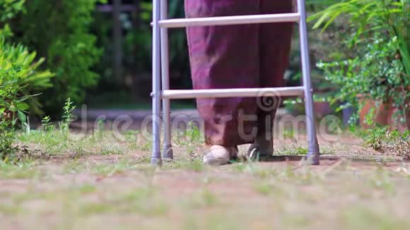 在后院用步行器的老年妇女视频的预览图