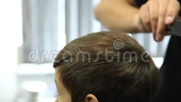 理发师理发的小男孩坐在椅子上视频的预览图