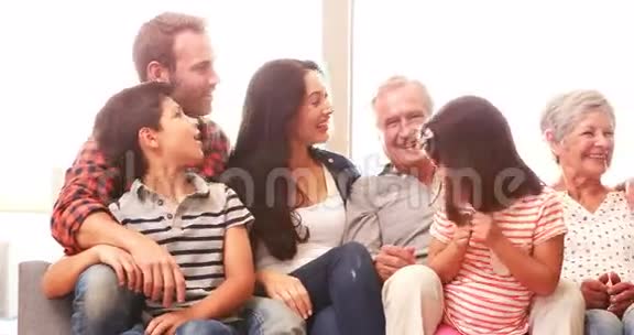 幸福的家庭坐在沙发上视频的预览图